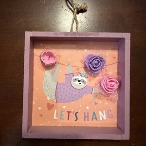 Girls hanging sloth shadow box with flowers